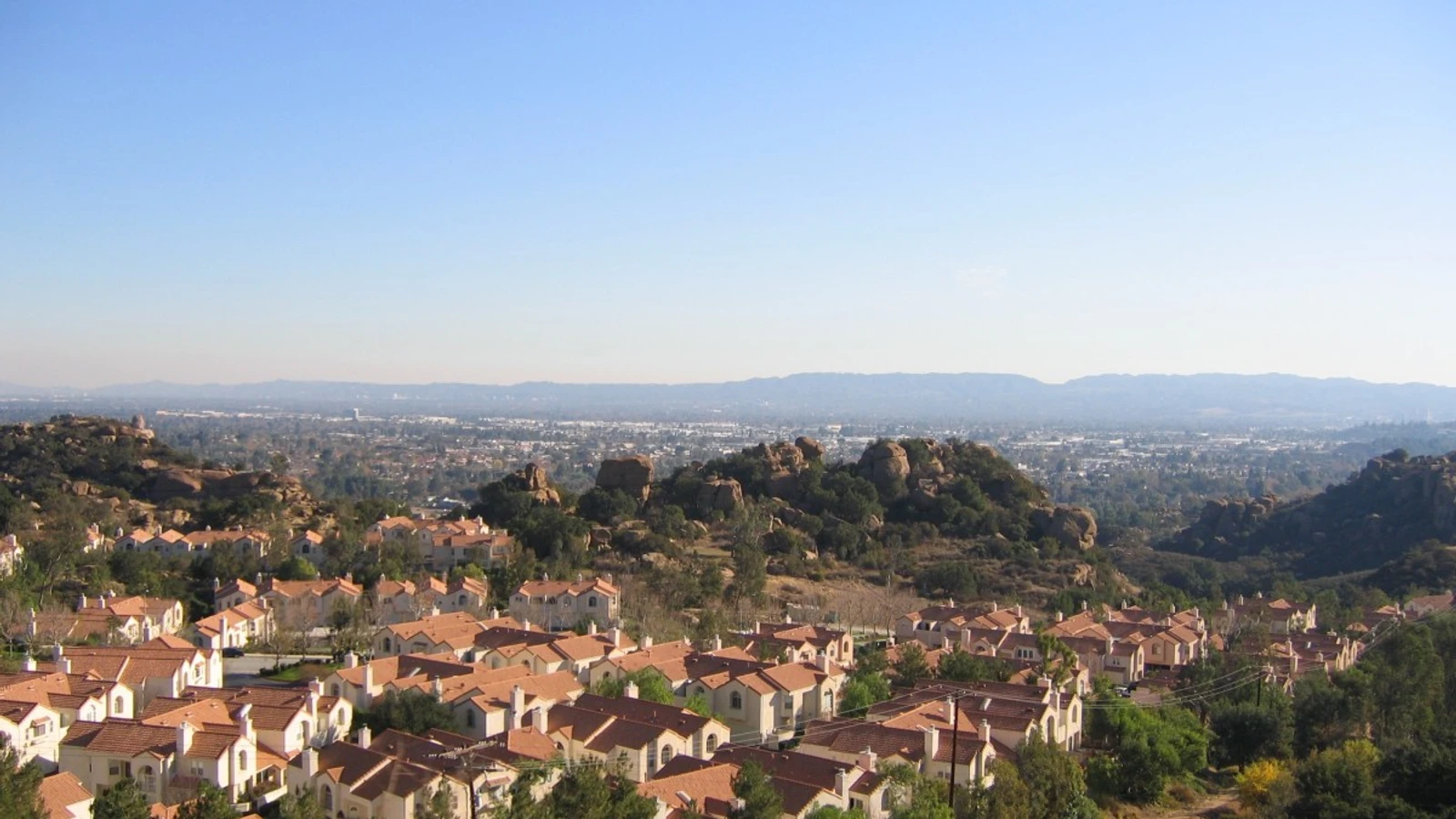 Residential rooftops illustrating housing finance, not identified as Redwood-owned properties; no text overlays.